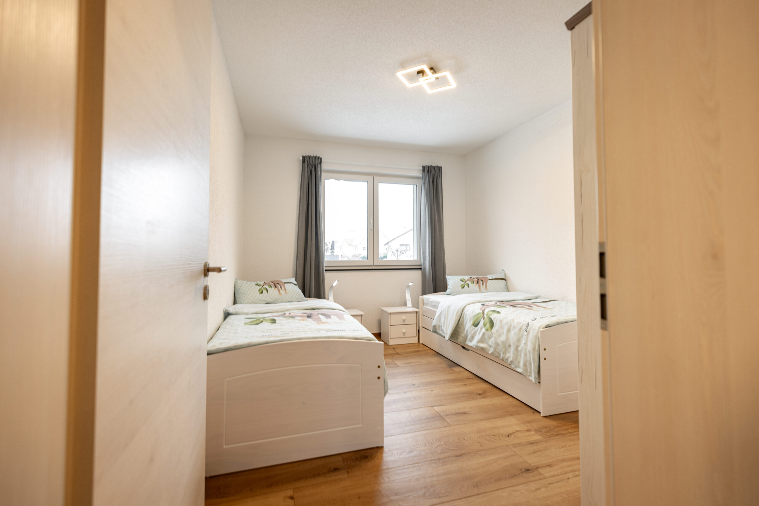 Das Schlafzimmer 2 der Ferienwohnung in Wangen im Allgäu ist gemütlich ausgestattet, mit zwei getrennten Betten.